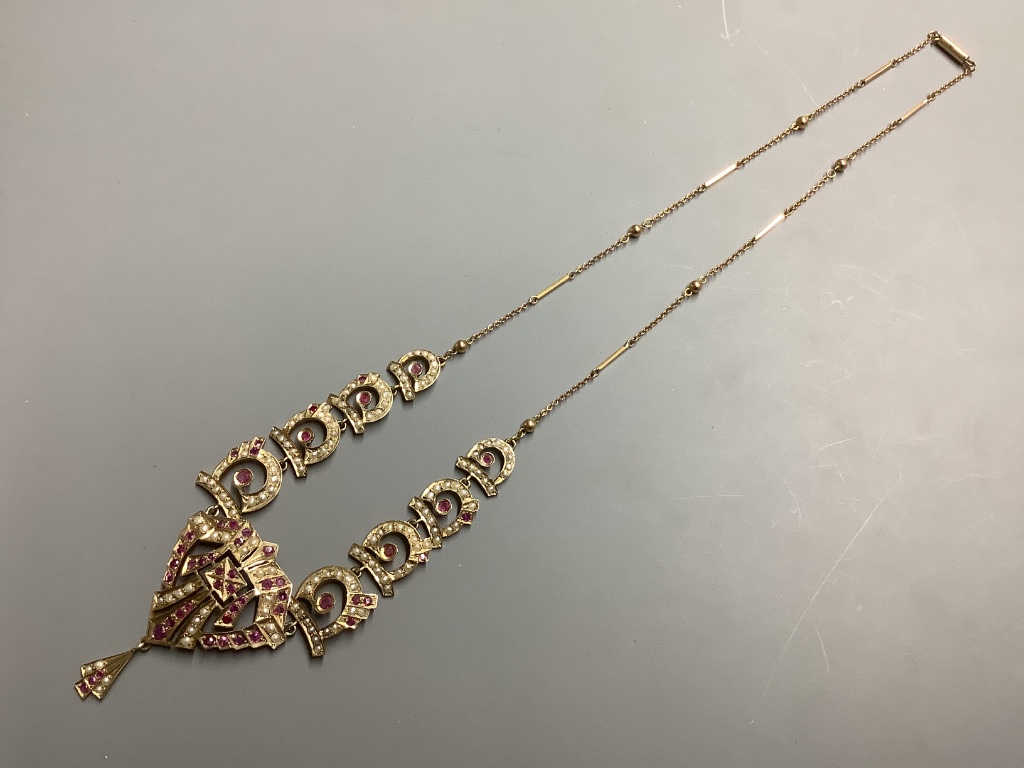 A yellow metal ruby and seed pearl set drop necklace, length 52 cm, gross weight 17.6 g.